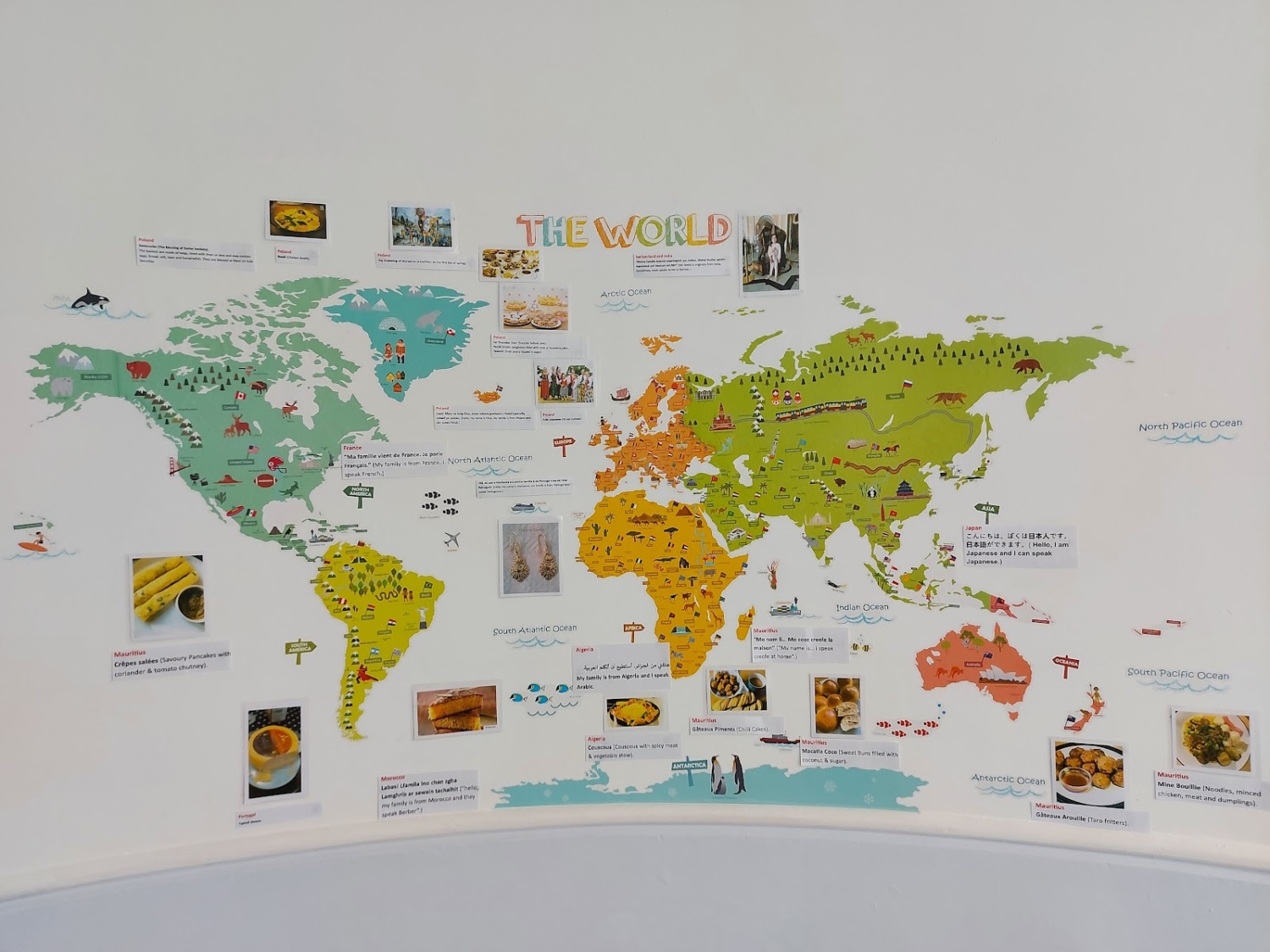 Photo of a map of the world with annotations and images around it to help children learn.