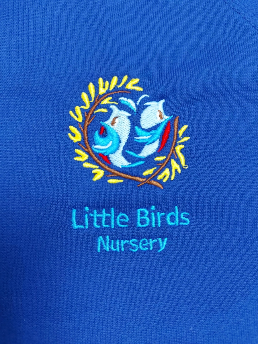 Close-up of the Little Birds Nursery logo on the Nursery jumper.