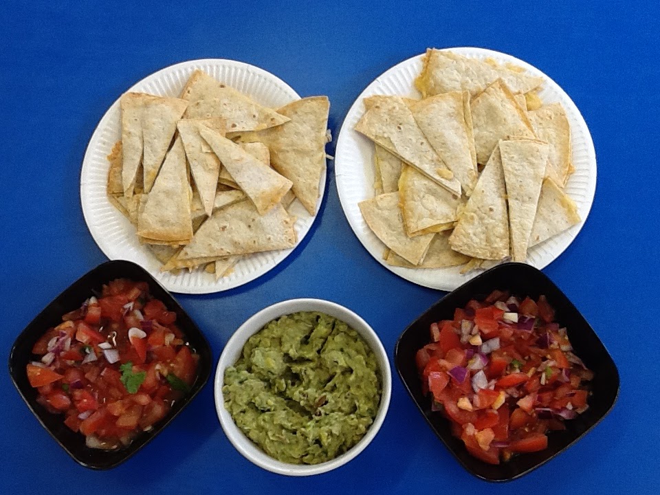 A photo of some Mexican snacks in bowls and plates.