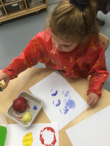 Young girl painting with vegetables