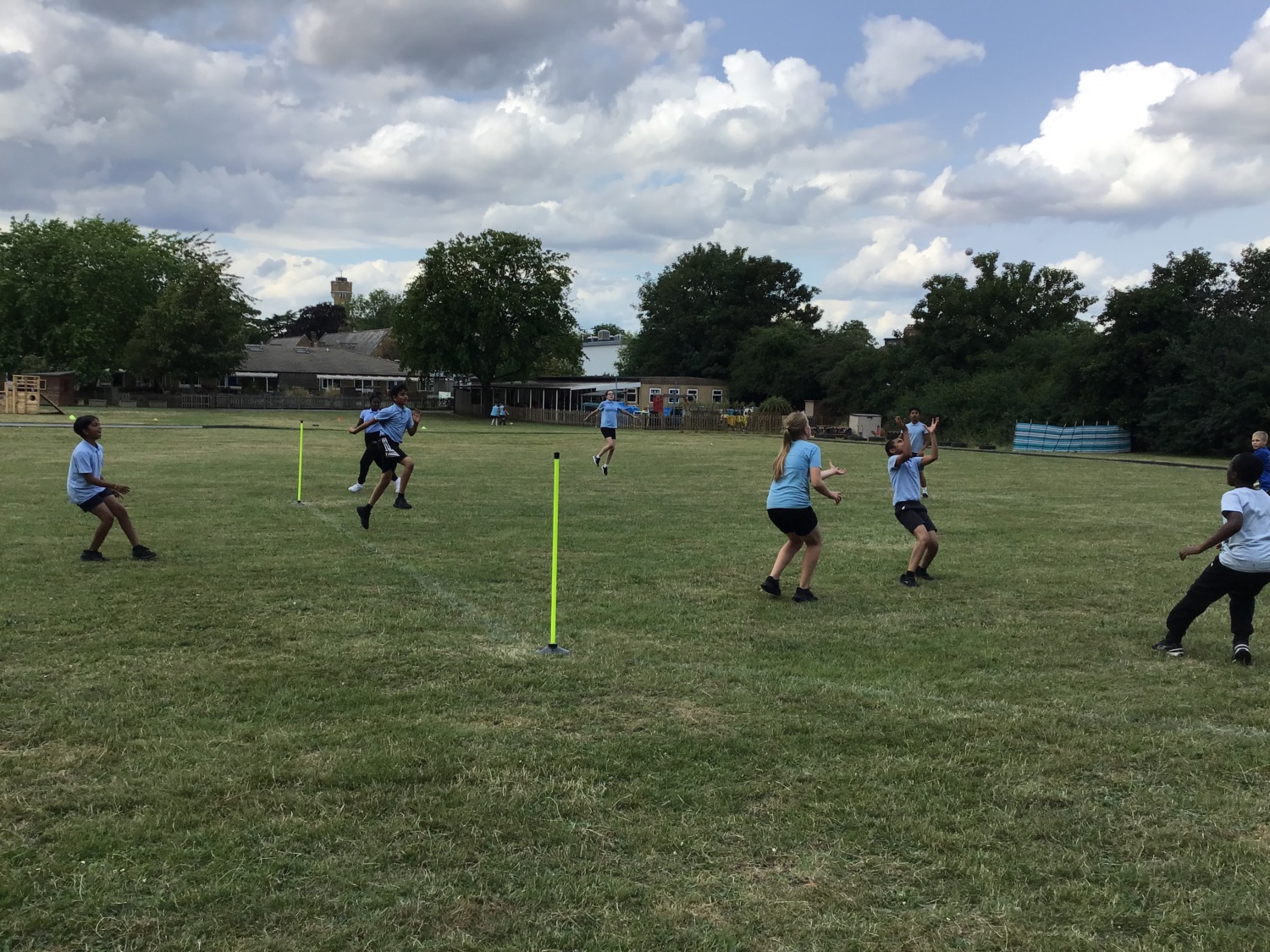 DPA students playing rounders in a field