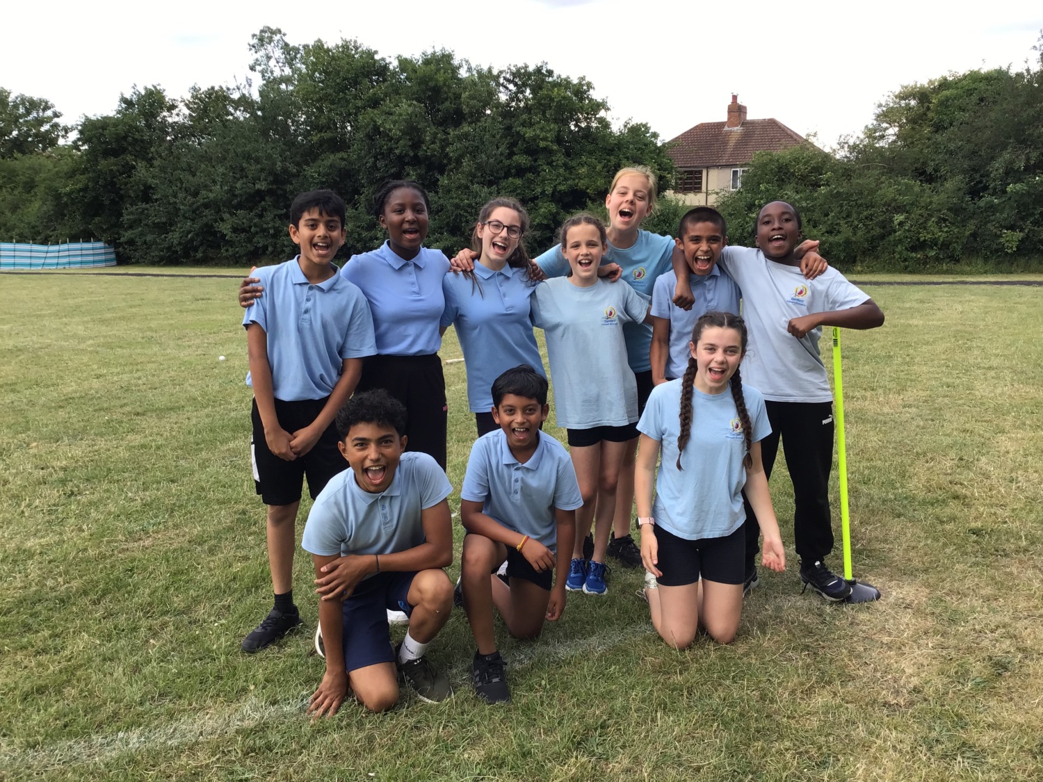DPA students celebrating their wins at rounders in a field