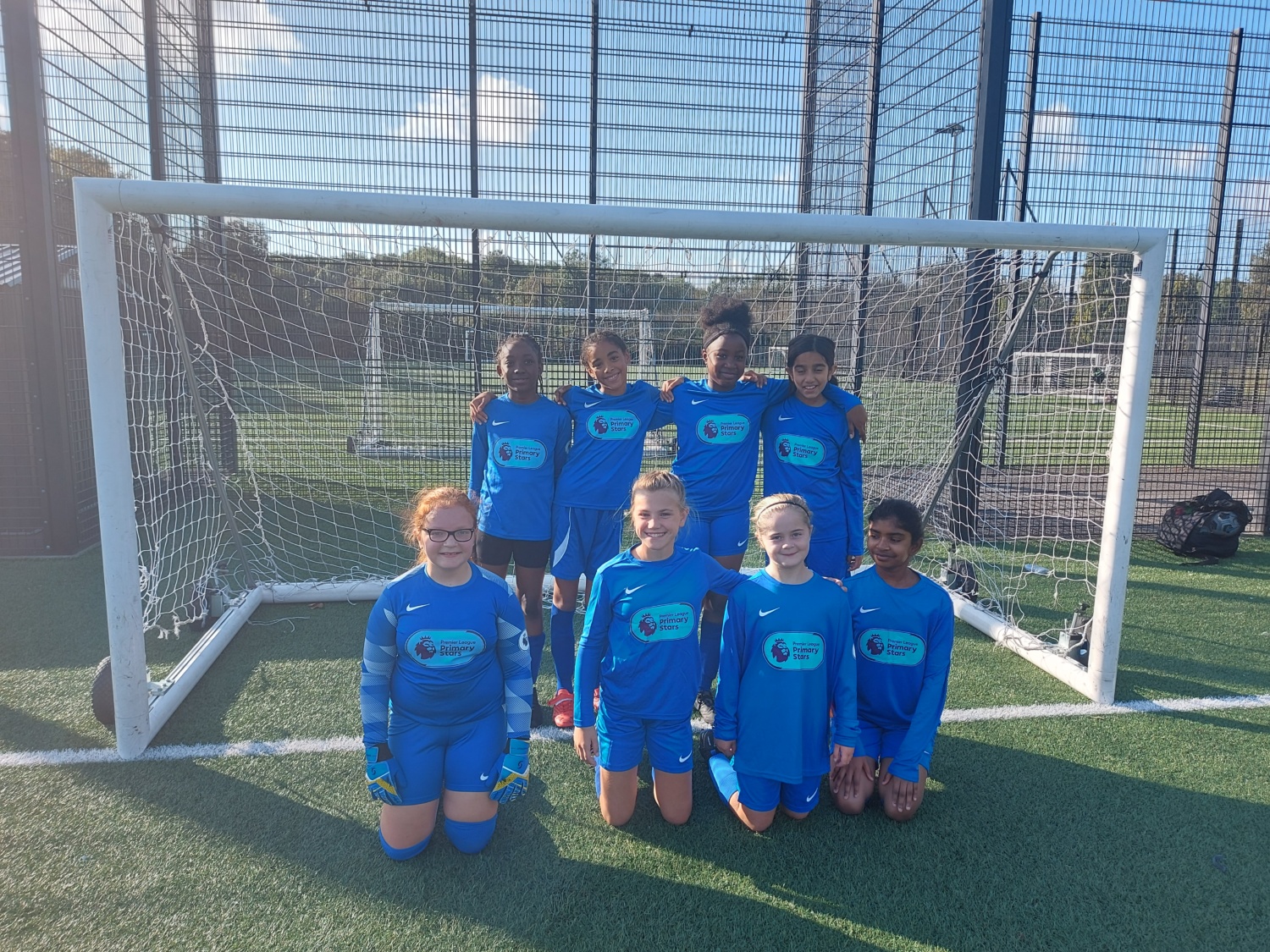 Eight DPA pupils are pictured kneeling down together under a goalpost for a group photo after having enjoyed success in their Football tournament.