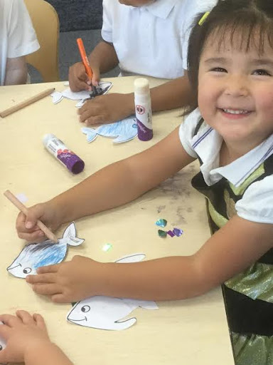 Nursery pupils are pictured creating artwork inspired by the story of 'The Rainbow Fish'.