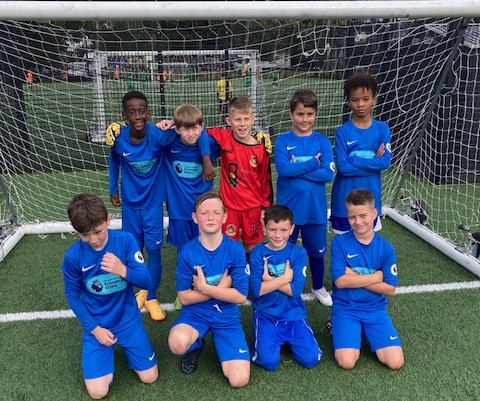 Photo of the Dartford Primary Academy Boys' Football Team posing for the camera together after having participated in a tournament.