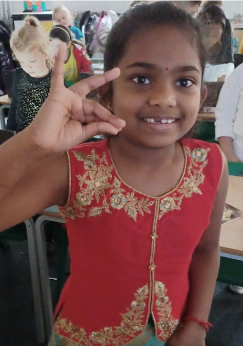 A female student seen practising a Hindu dance in her classroom.