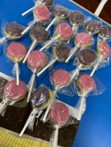 A photo showing a variety of lollipops laid out across a table, ready to be sold by Dartford Primary pupils to other pupils.