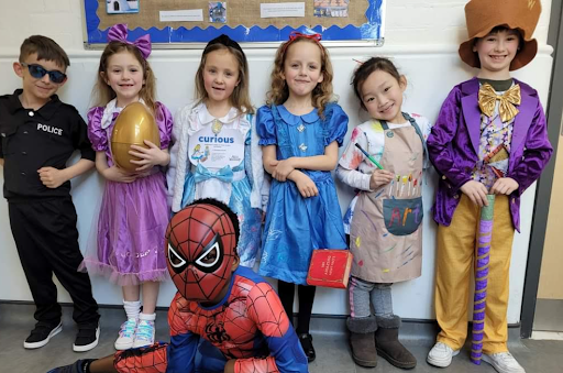 A group of DPA students are pictured smiling for the camera, whilst wearing their fancy dress outfits on World Book Day 2024.
