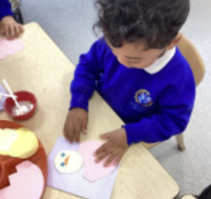A child using arts and craft supplies for Easter creations